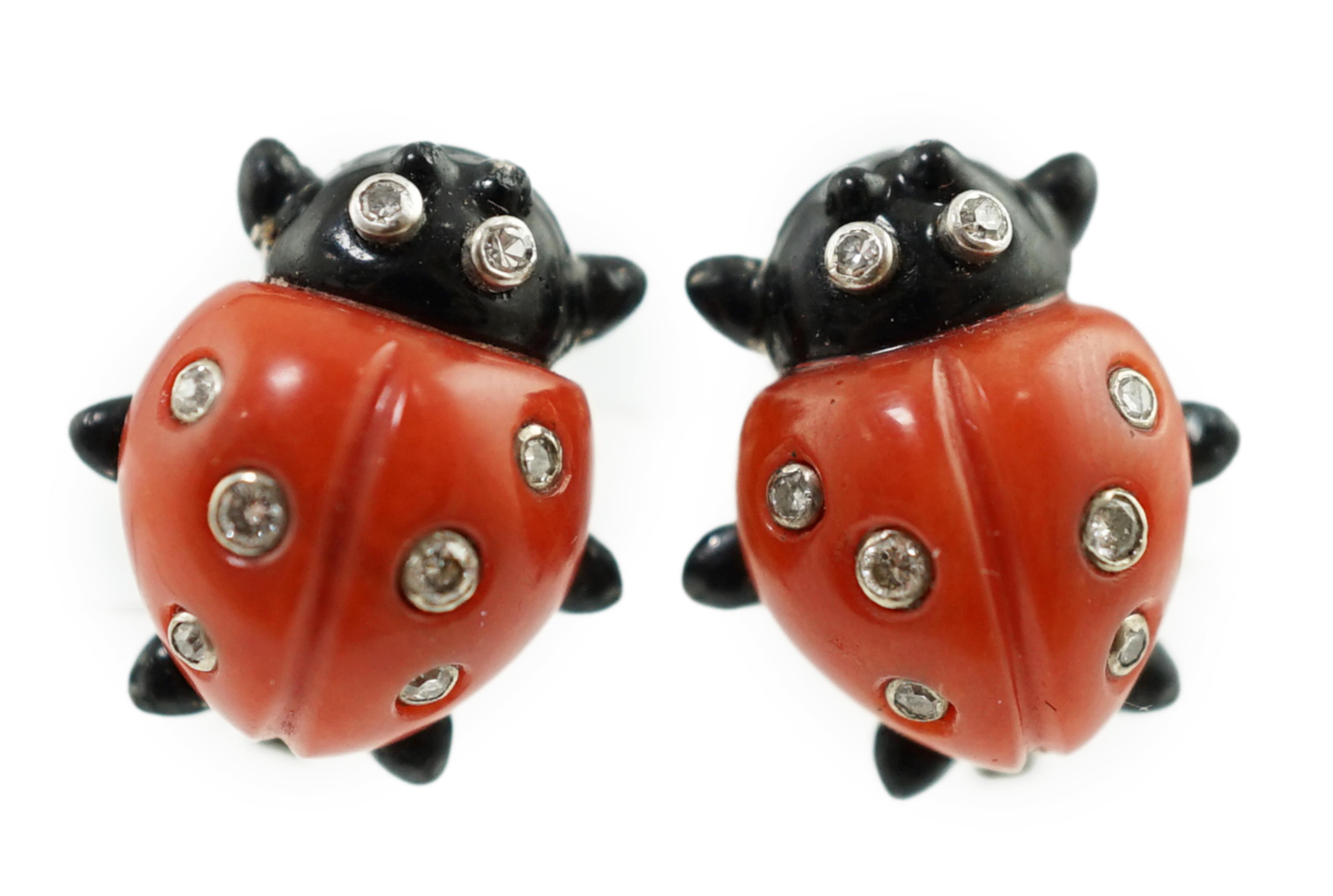 A pair of white metal, enamel, coral and diamond ladybird ear clips, bearing Cartier, New York signature and inscribed 18k